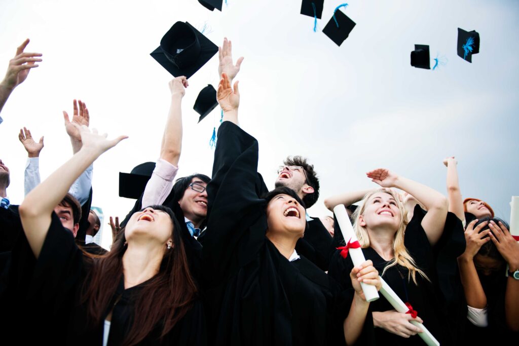 Maruthi-group-diverse-grads-throwing-caps-up-sky