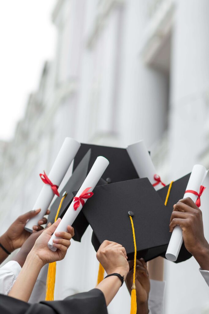 close-up-hands-holding-diplomas-caps (1)